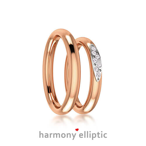 Produktfotografie des Trauringpaars Harmony Elliptic in Weißgold, mit mehreren hervorgehobenen Diamanten im Damenring