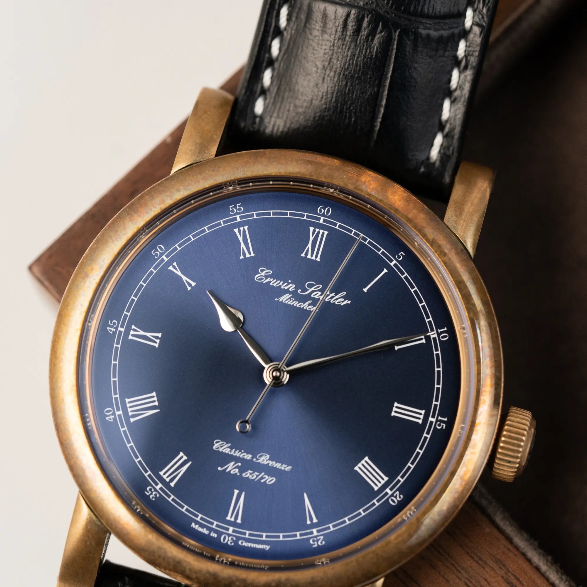 Detailaufnahme des Uhrenkopfes der limitierten Erwin Sattler Classica Armbanduhr in einem Bronze-Gehäuse mit wunderbarer Patina und mit blauem Zifferblatt