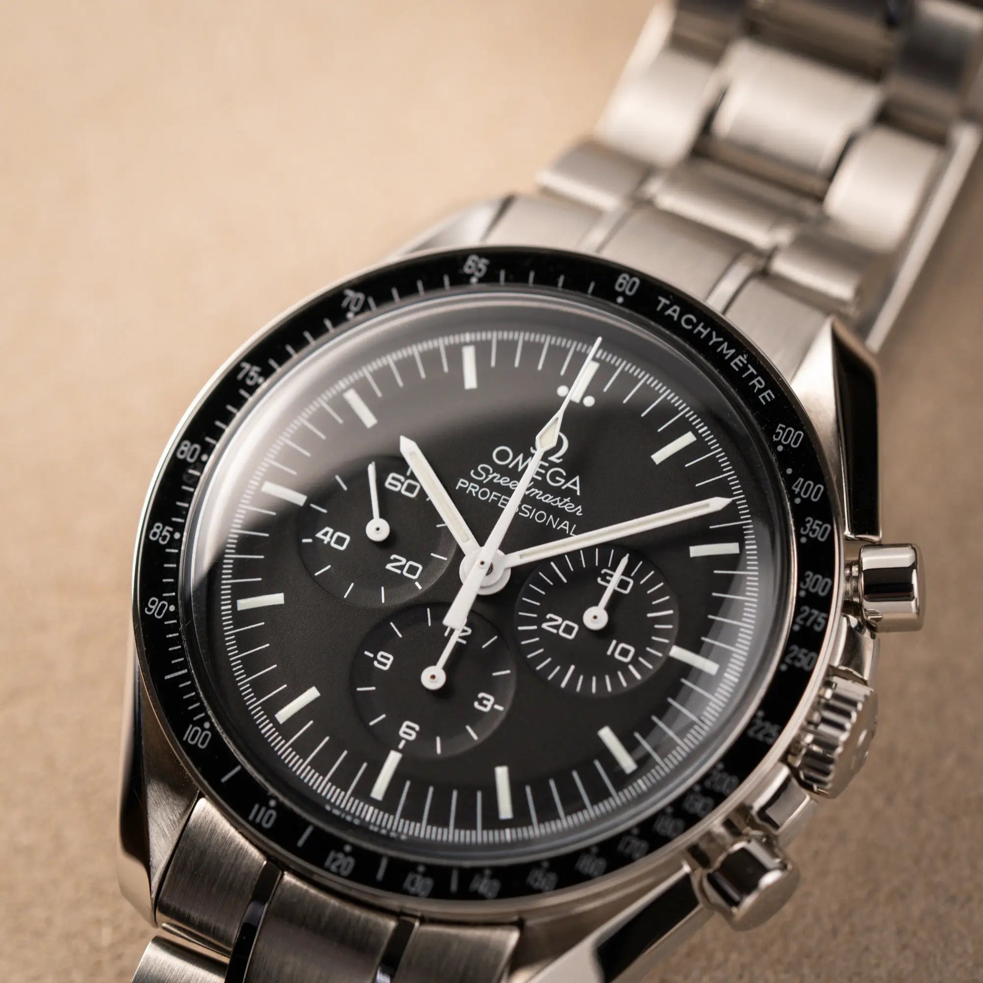 Detailaufnahme des schwarzen Zifferblatts der Omega Speedmaster Professional Moonwatch mit Hesalitglas aus 2018