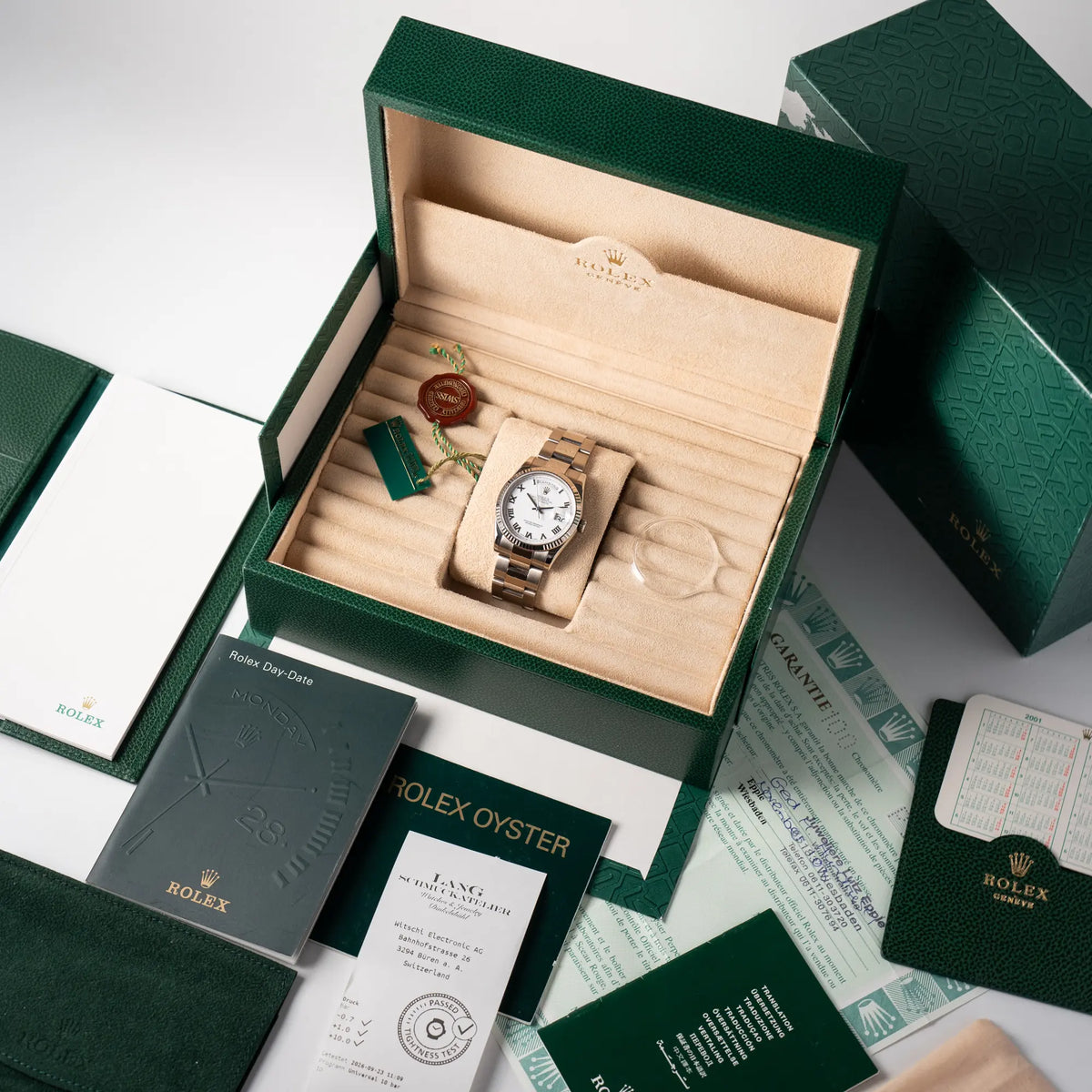 Rolex Day-Date 36 Armbanduhr in Weißgold der Referenz 118239 mit weißem Zifferblatt mit römischen Indizes am Oyster-Weißgold-Armband zusammen mit dem Lieferumfang, welcher alle original mit ausgelieferten Teile weiterhin beinhaltet und omit ein Collector-Set bildet