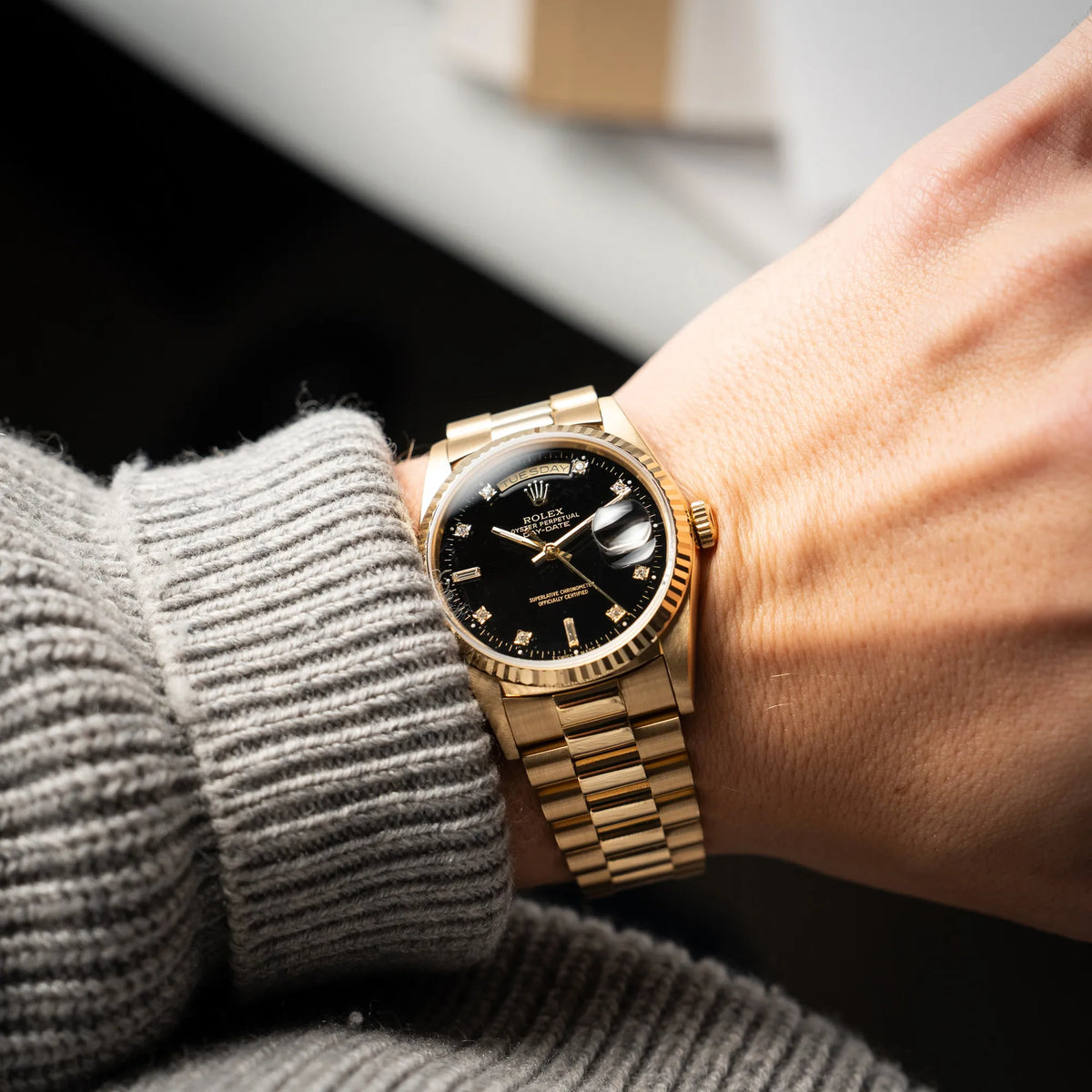 Wristshot mit der Rolex Day-Date 36 der Referenz 18238 in Gelbgold mit schwarzen Diamond-Dial am President-Armband
