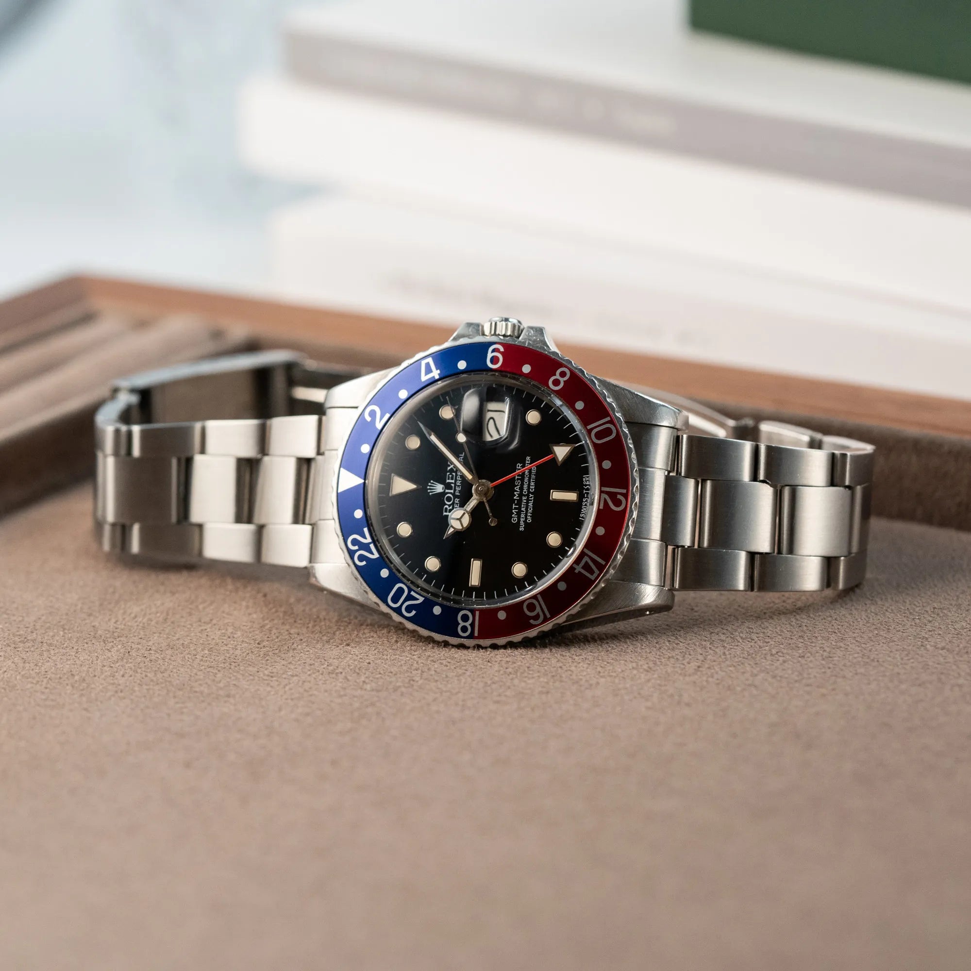 Produktfoto der der Rolex GMT Master 1675 mit dem Nickname Pepsi mit blau-roter Lynette auf Juwelierstablet