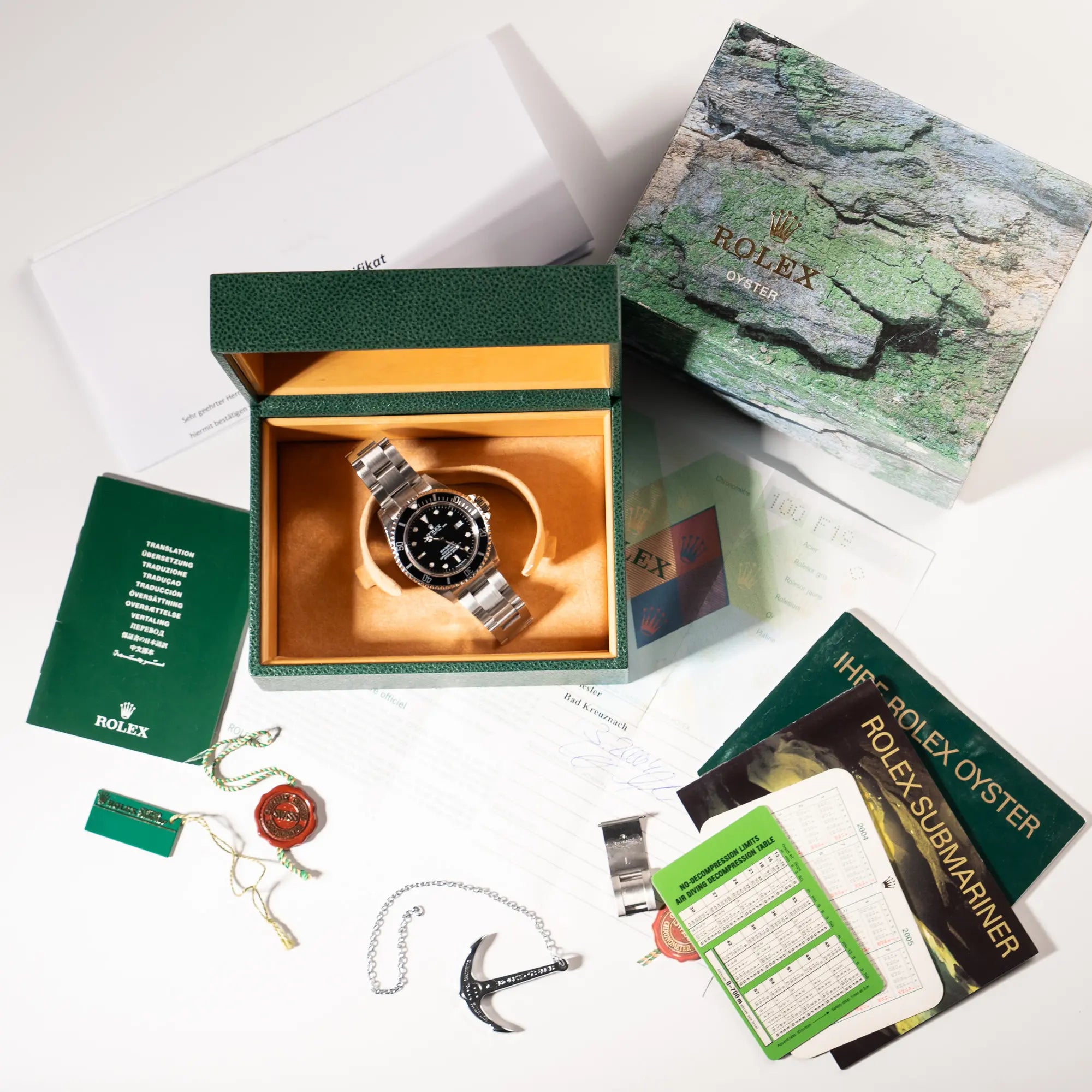 Lieferumfang zu der Rolex Sea-Dweller 4000 in schwarz der Referenz 16600 mit typischen kleinem Datumsfenster, bestehend aus Box, Umkarton, Hangtags, Rolex-Anker, Kalendern, Papieren und Service-Beleg