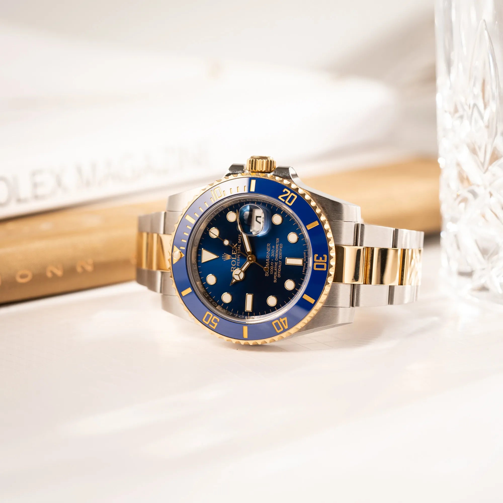Detailreiche Produktfotografie zeigt den Sonnenschliff des Zifferblatts von der Rolex Submariner Date der Referenz 116613LB in Stahl-Gold mit blauem Zifferblatt - auch mit Nickname Bluesy bennant - am passenden Oytser-Armband in Stahl-Gold