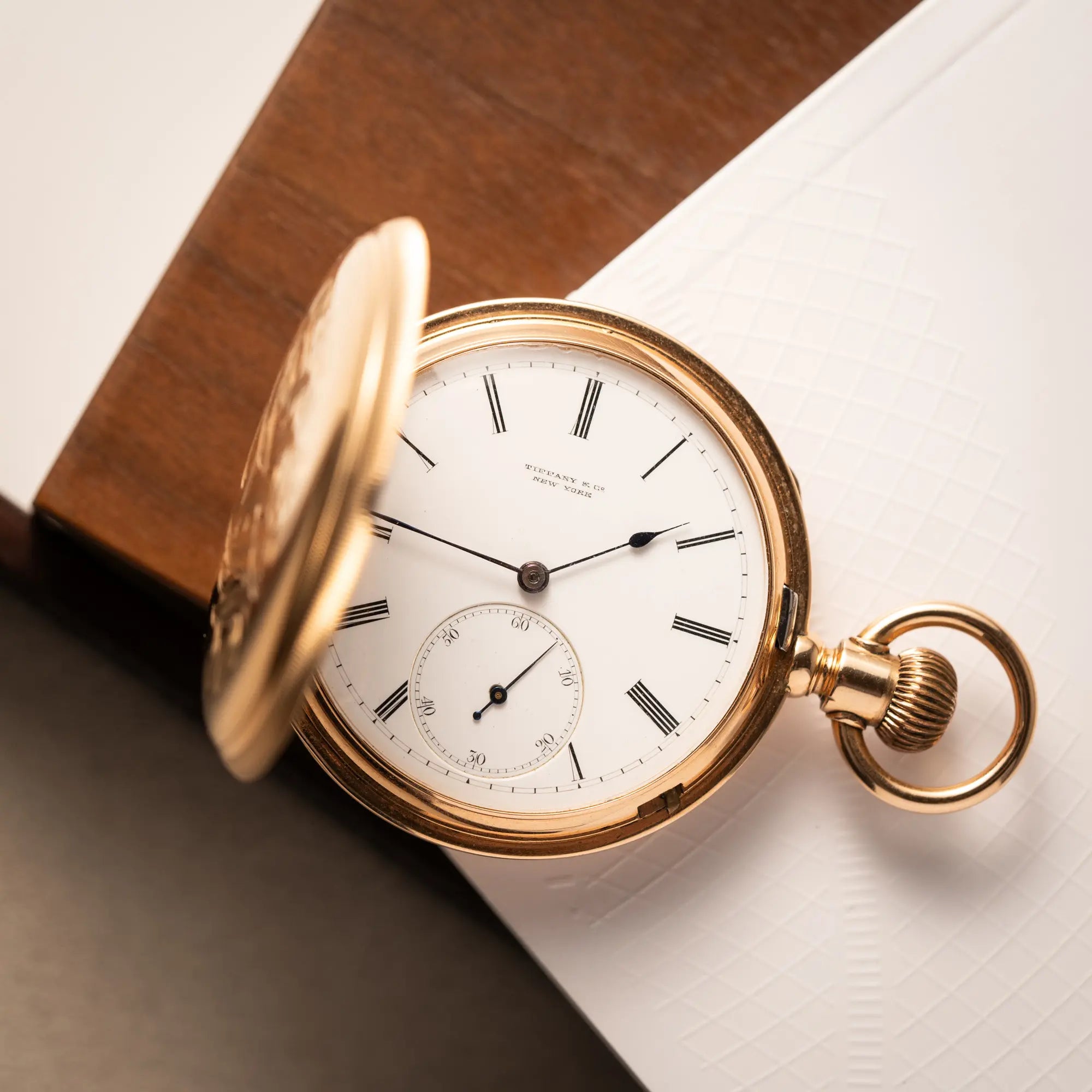 Produktfotografie der Tiffany & Co Savonette Taschenuhr aus 18k Gelbgold mit weißem Zifferblatt und römischen Indizes