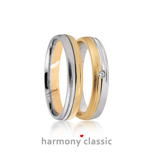 Produktfotografie des Trauringpaars Harmony Classic in Gelbgold und Weißgold (Bicolor) mit einem Diamanten im Damenring
