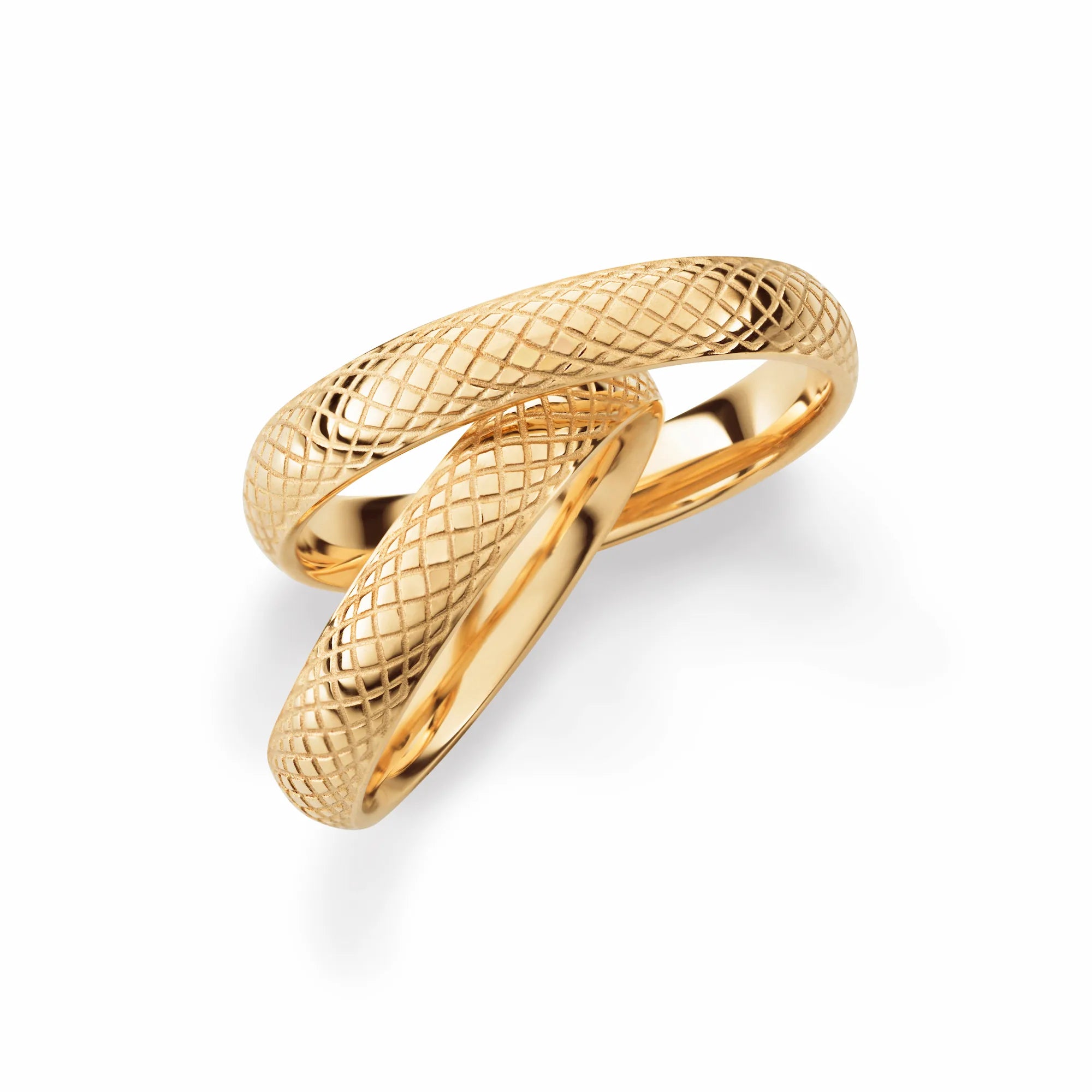 Produktfotografie des gelbgoldenen Max Kemper Trauringpaars mit einer Oberfläche mit geriffeltem Muster