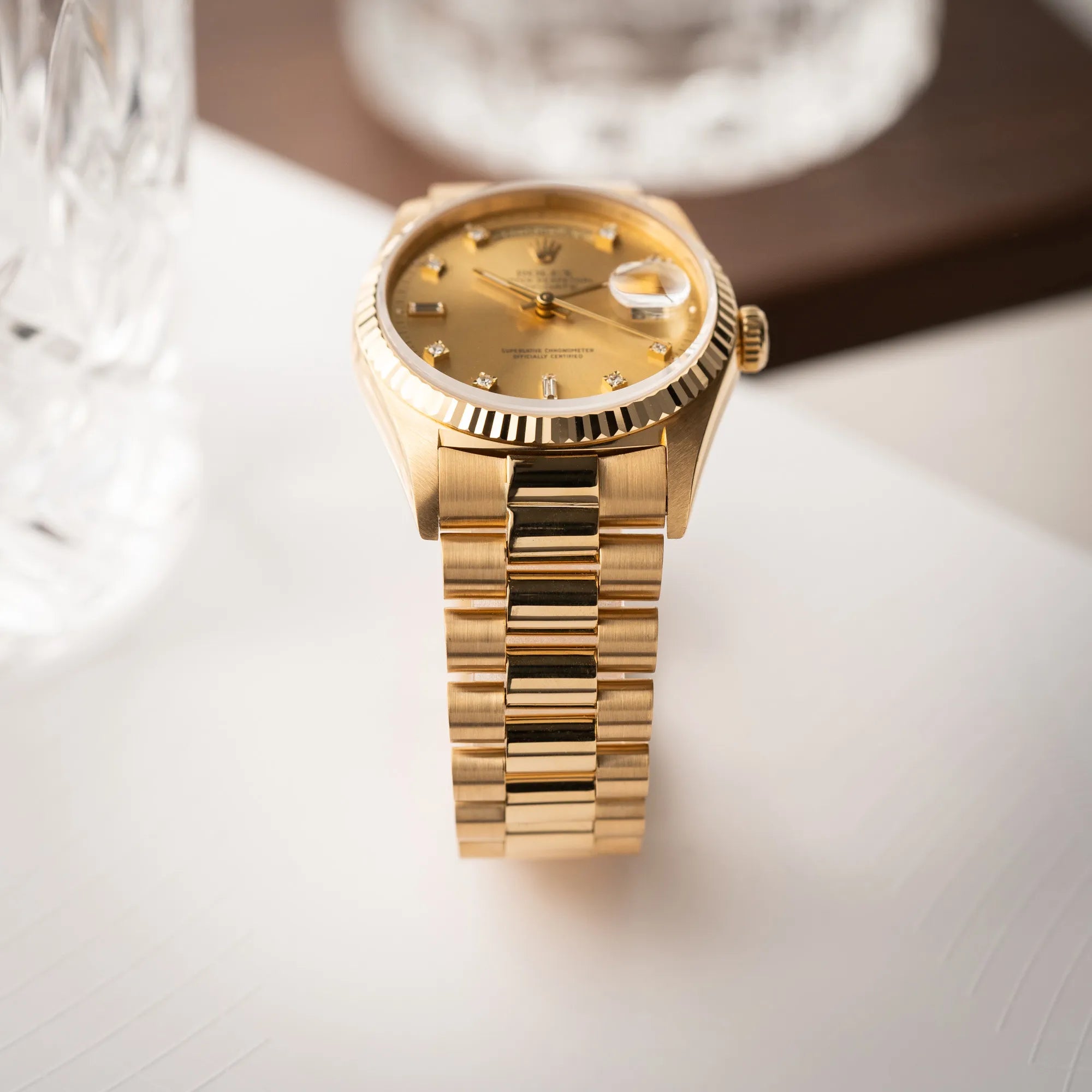 Produktfotografie der Rolex Day-Date 36 in Gelbgold der Referenz 18238 aus 1991 mit Champagner-Diamant-Zifferblatt und englischsprachiger Tagesanzeige zeugt das President-Armband