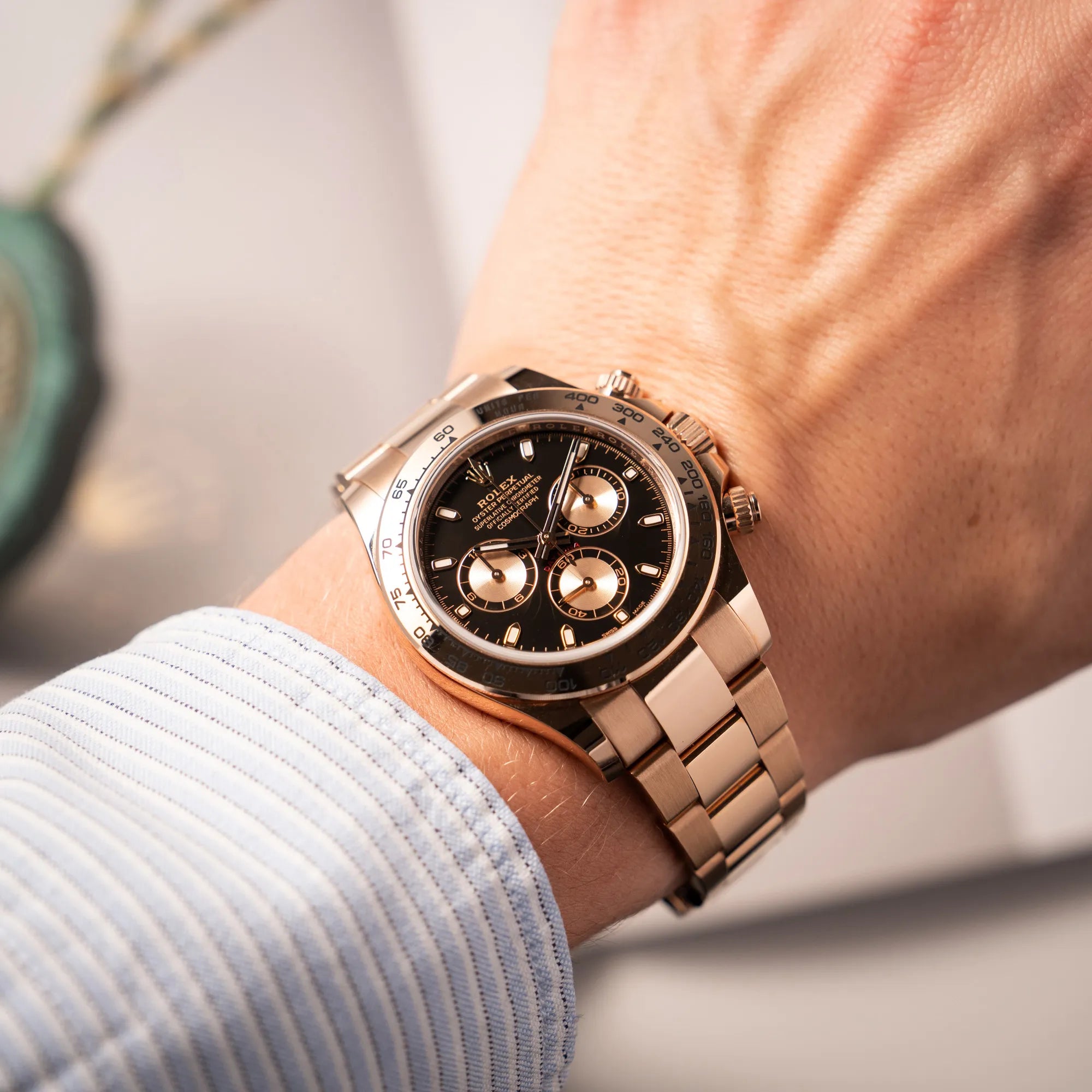 Wristshot mit der Rolex Daytona Chronograph-Armbanduhr der Referenz 116505 in Everrose-Roségold mit schwarzem Zifferblatt am Oyster-Roségold-Band an einem Männerhandgelenk