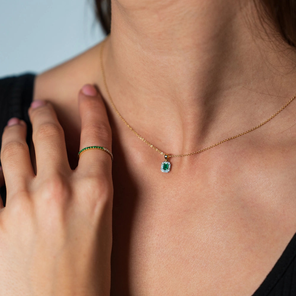 Frau kombiniert das Smaragd Collier und den passenden Ring mit Brillanten und Smaragden aus der SL Collection