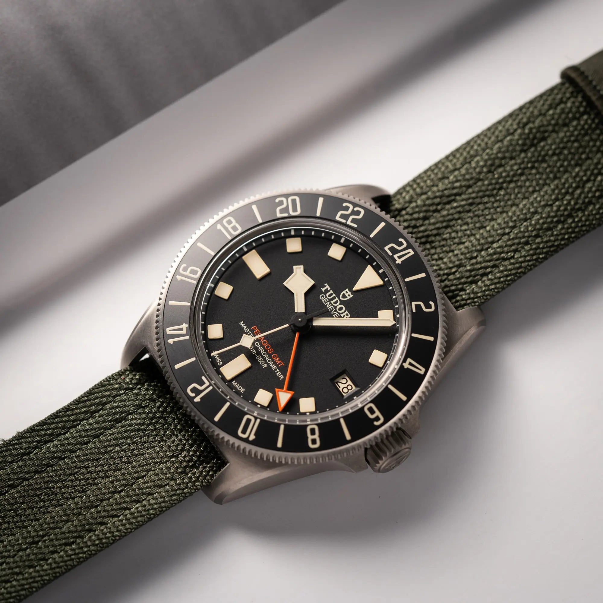 Simple Produktfotografie derTudor Pelagos GMT Military der Referenz M2542G257NU-0002 mit Titan-Gehäuse und schwarzem Zifferblatt an einem olivgrünen Nato-Strap