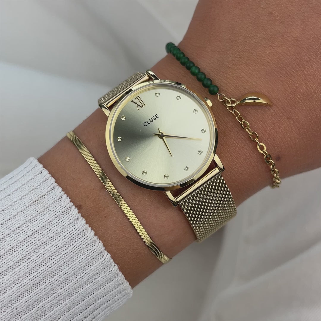 Produktvideo der goldfarbenen Cluse Damenuhr Minuit CW10204 mit rundem Gehäuse, einem goldfarbenem Zifferblatt mit Zirkonia-Steinen als Indizes und einem feinem Mesh-Uhrenarmband